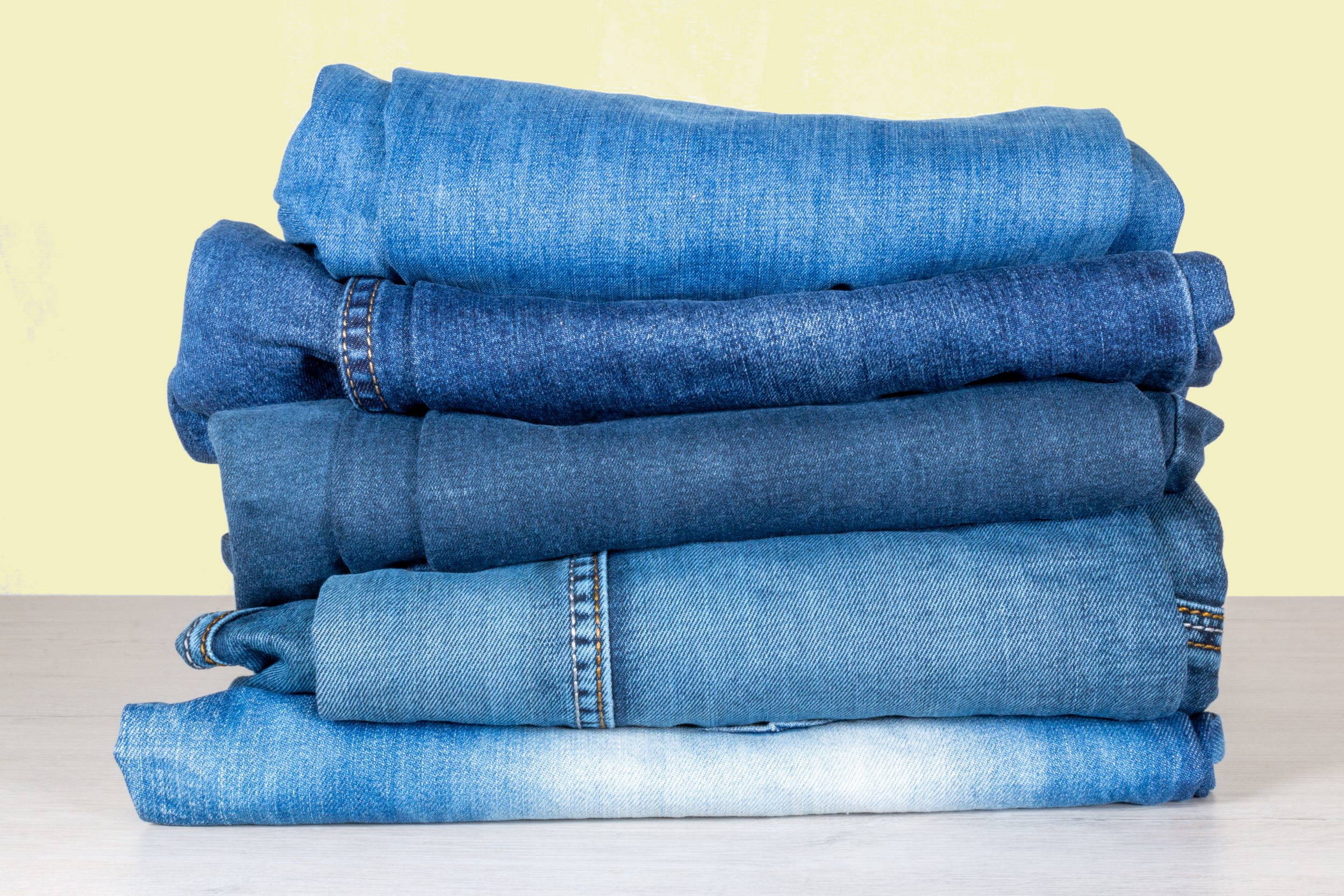 Jeans Yellow Background Shutterstock 1939221682